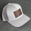 Leather Patch Performance Style Trucker Hat - Texas License Plate Stamp