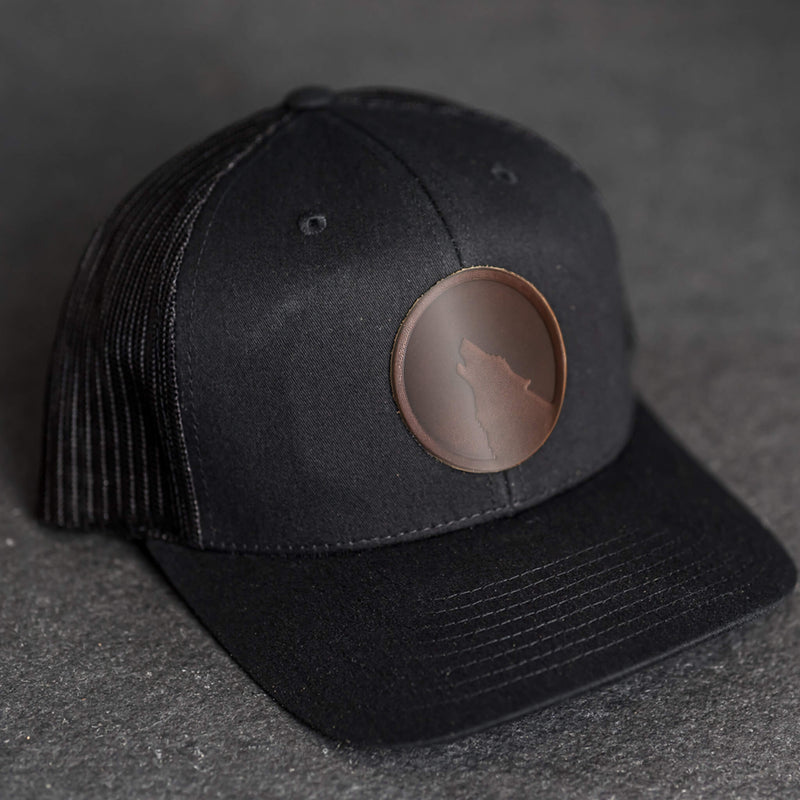 Leather Patch Trucker Style Hat - Wolf Stamp