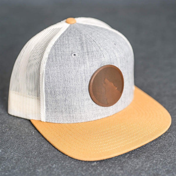Leather Patch Flat Bill Trucker Hat - Wolf Stamp