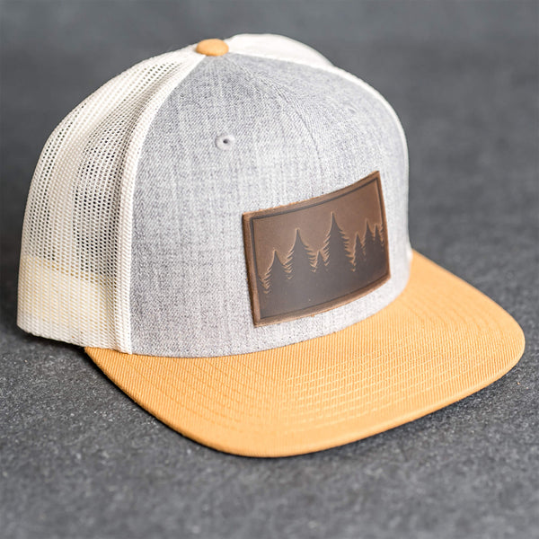 Leather Patch Flat Bill Trucker Hat - Pine Trees Stamp