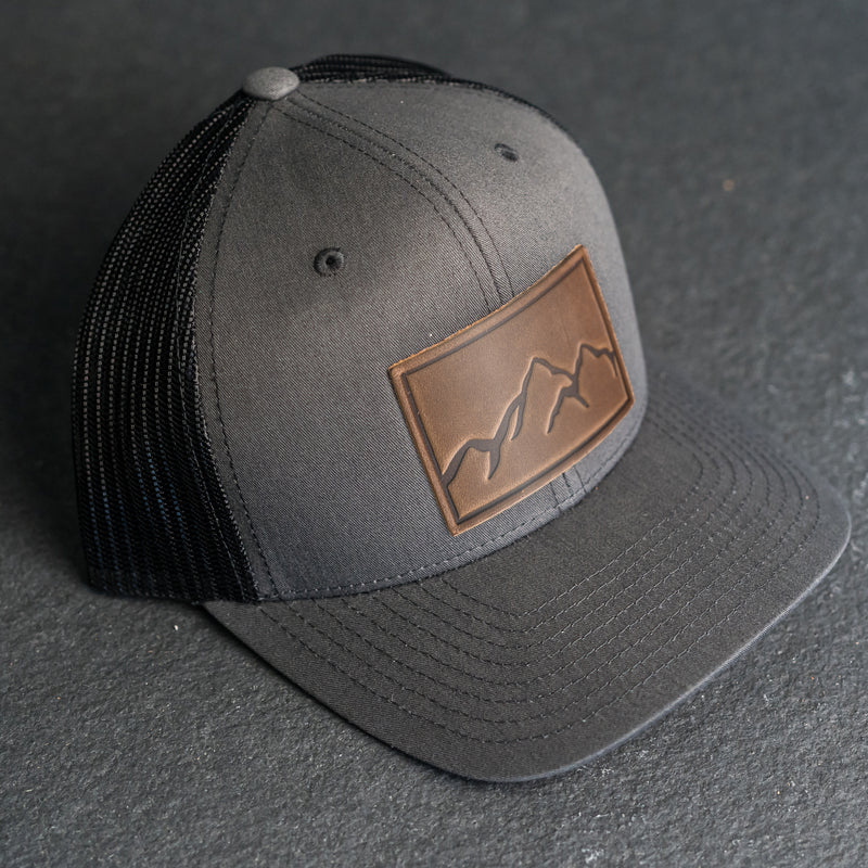 Leather Patch Trucker Style Hat - Mountain Range Stamp