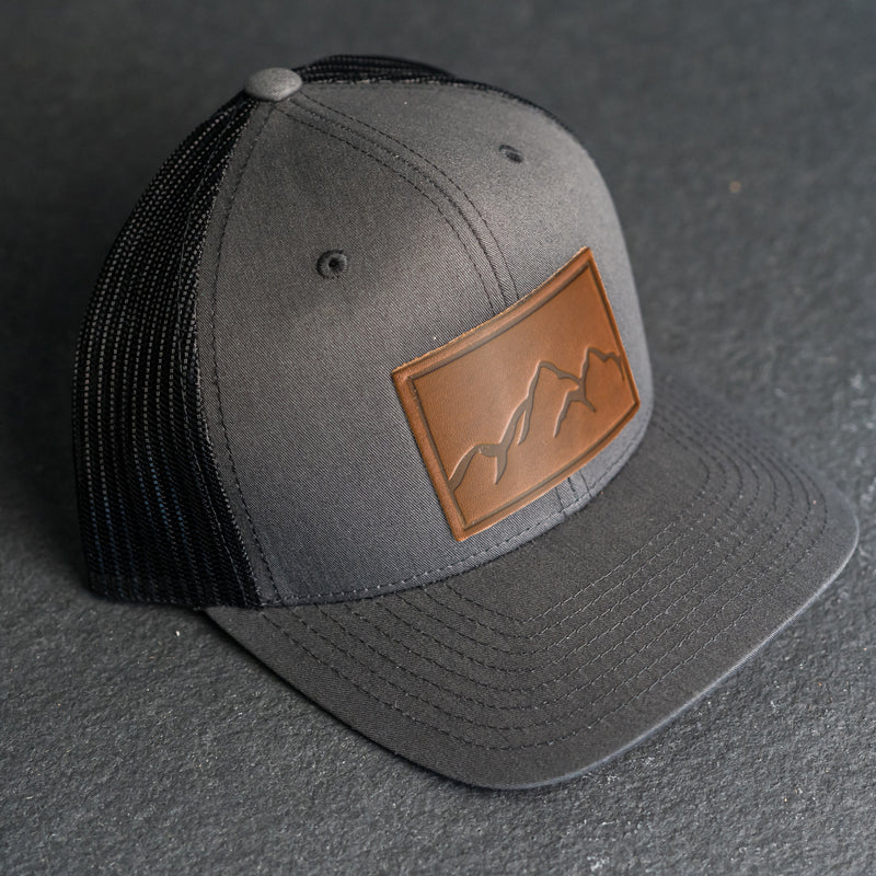 Leather Patch Trucker Style Hat - Mountain Range Stamp