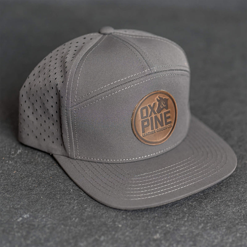 Leather Patch Flat Bill 7 Panel Perforated Performance Hat - Ox & Pine Logo Stamp - Circle