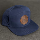 Leather Patch Flat Bill 7 Panel Perforated Performance Hat - Ox & Pine Logo Stamp - Circle