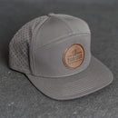Your Logo on a Leather Patch Flat Bill 7 Panel Perforated Performance Hat - Circle Patch