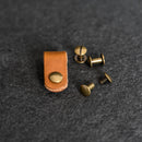 Brown leather strap end with brass rivets