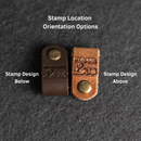Two brown leather labels with brass stamps 