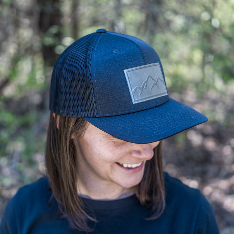 Leather Patch Performance Style Trucker Hat - Mountain Range Stamp