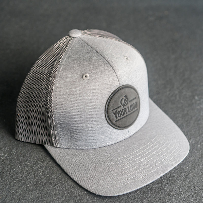 Your Logo on a Leather Patch Performance Style Trucker Hat - Circle Patch